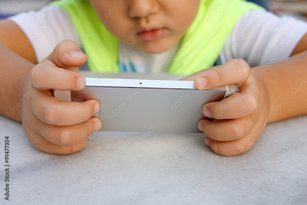 Little boy playing games on smartphone Little boy playing games on smartphone