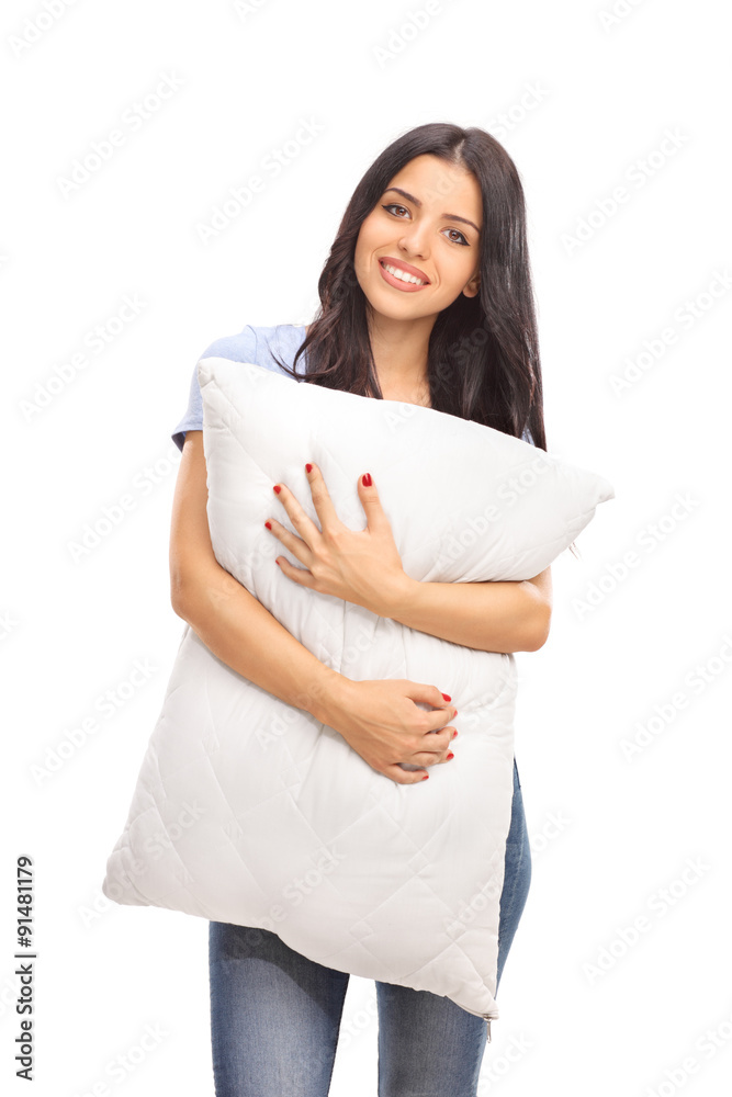 Vertical shot of a young woman hugging a pillow Vertical shot of a young woman hugging a pillow