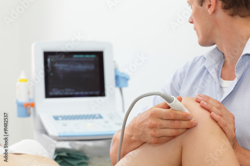 female patient's knee joint dynamic test carried out with the use of an ultrasound photo