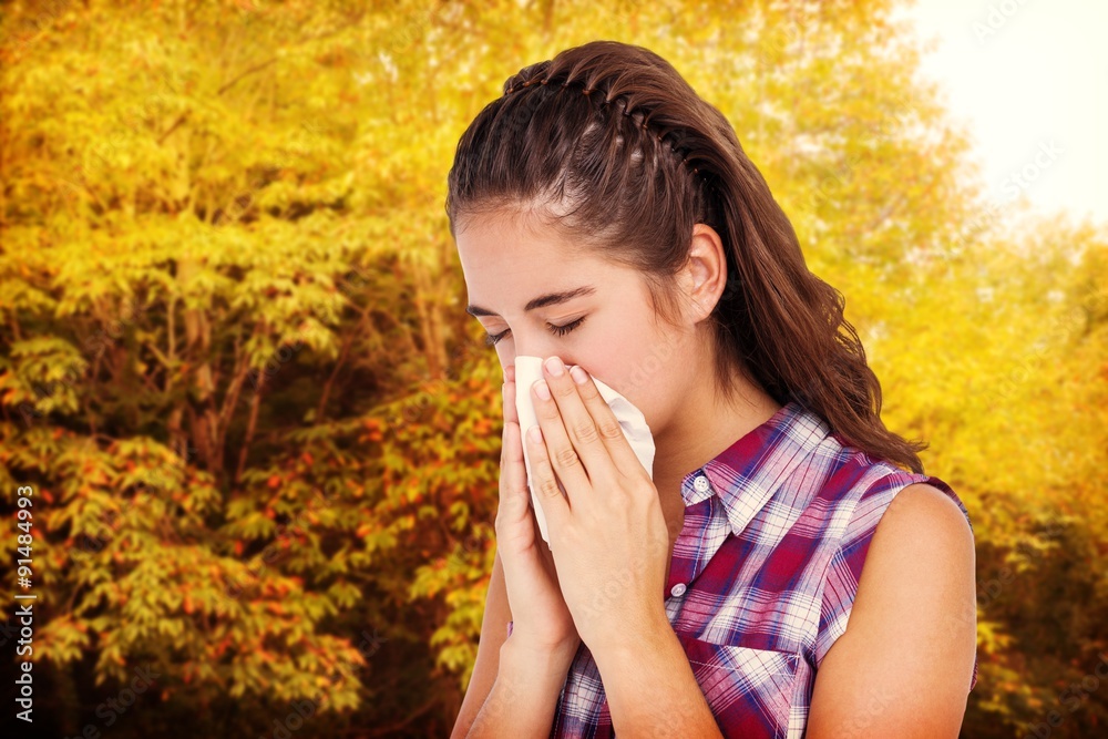 Composite image of sick woman sneezing in a tissue Composite image of sick woman sneezing in a tissue