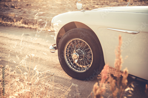 Vintage car wheel at sunset - vintage effect