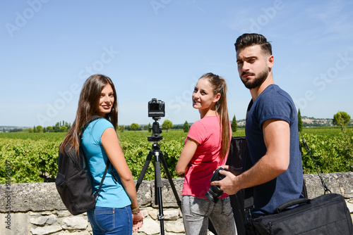 group of young student photographer taking pictures on photography shooting workshop course outdoor