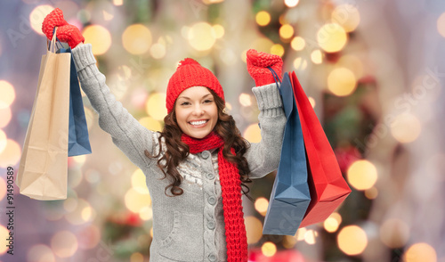 happy woman in winter clothes with shopping bags photo