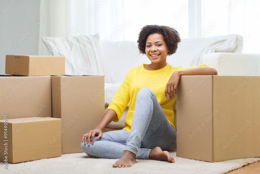 happy african woman with cardboard boxes at home happy african woman with cardboard boxes at home