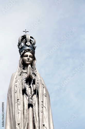ancient statue of our Lady with clasped hands