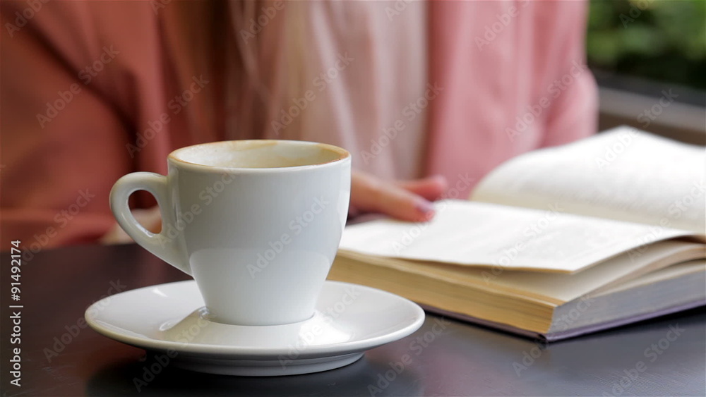 Book and a cup of coffee on the table Stock Video | Adobe Stock
