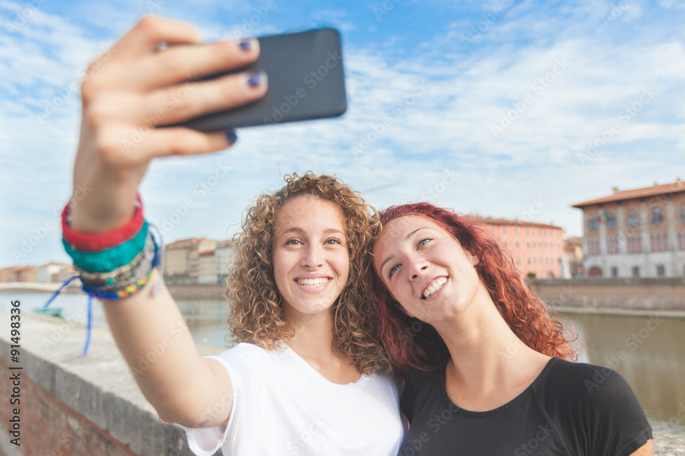 Two girls taking a selfie in the city Two girls taking a selfie in the city