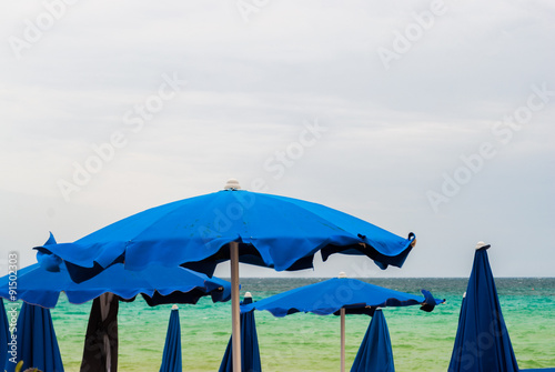 Beach umbrellas in a lido during a summer storm