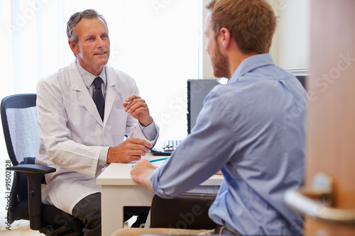 Male Patient Having Consultation With Doctor In Office