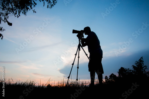 silhouette photographer at sunrise