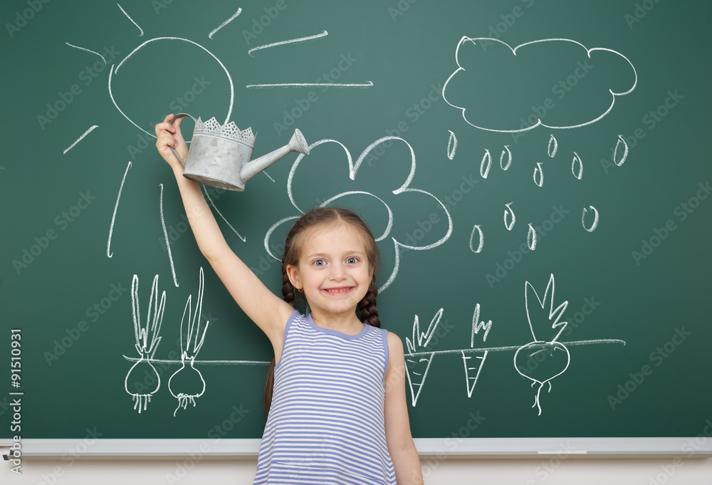 girl with watering can drawing on school board