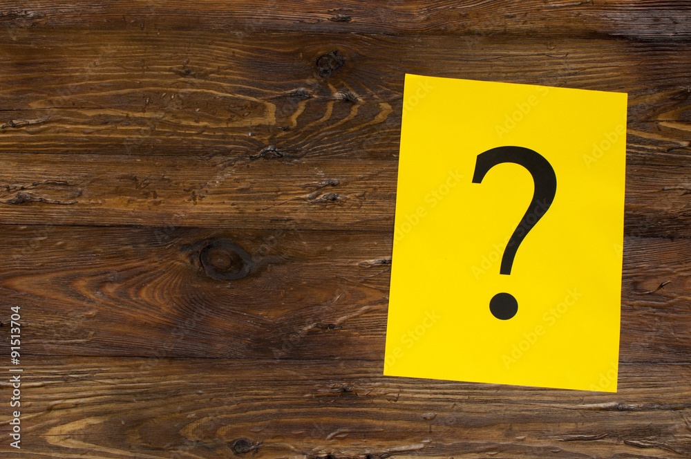 question marks on paper on wooden table question marks on paper on wooden table