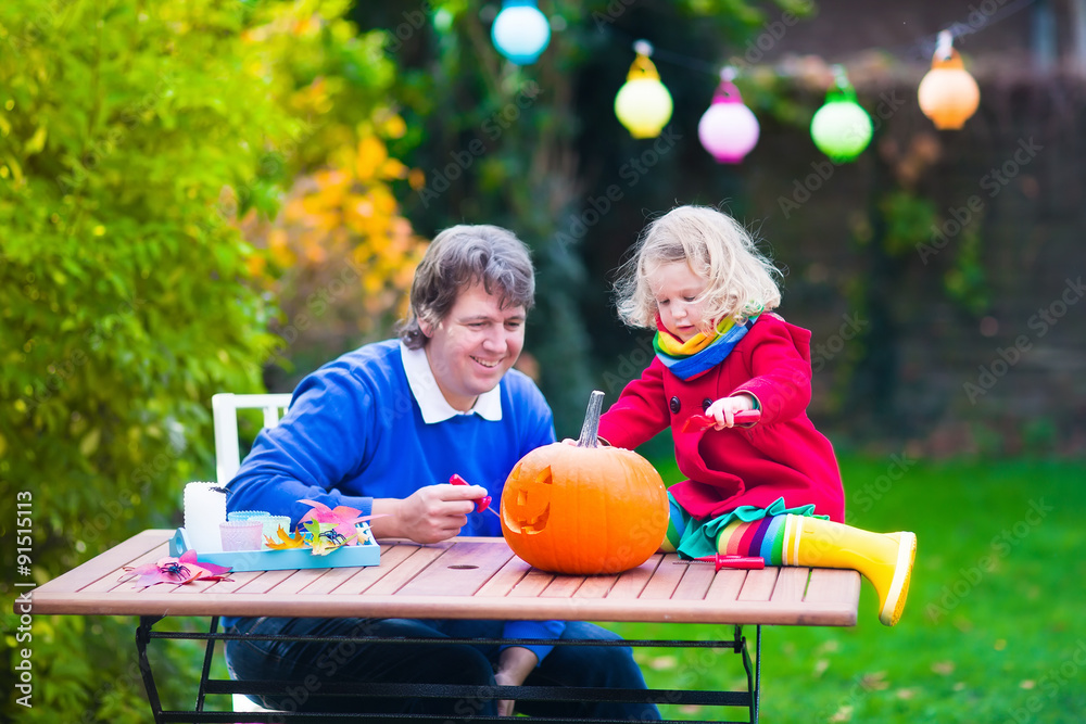 Fototapeta premium Family carving pumpkin at Halloween