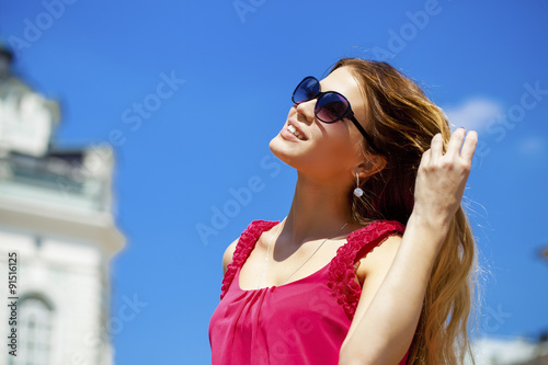 Charming happy blonde girl in sunglasses