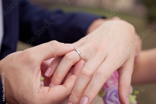 proposal with golden rings on the hand of the groom