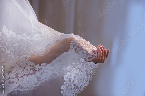 Obraz na płótnie Lace veil in the hand of the bride