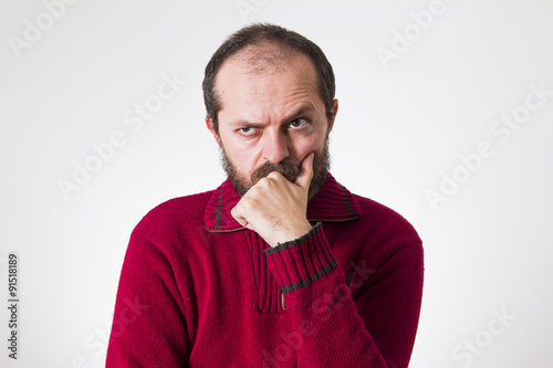 Photography Man in red sweater, with beard and mustaches, confused and skeptic
