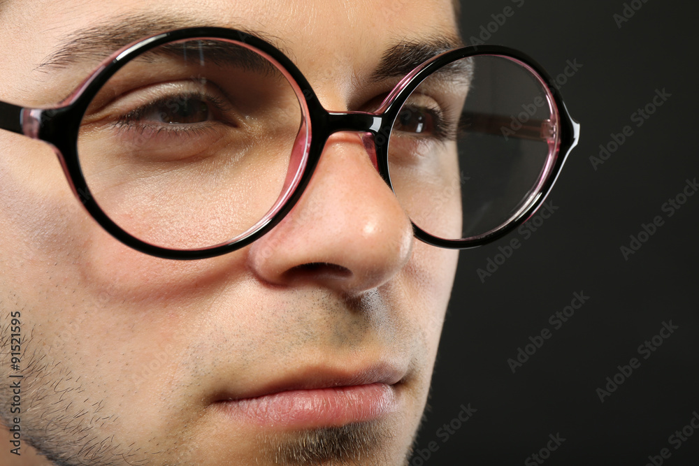 Attractive young man with glasses on gray background Attractive young man with glasses on gray background