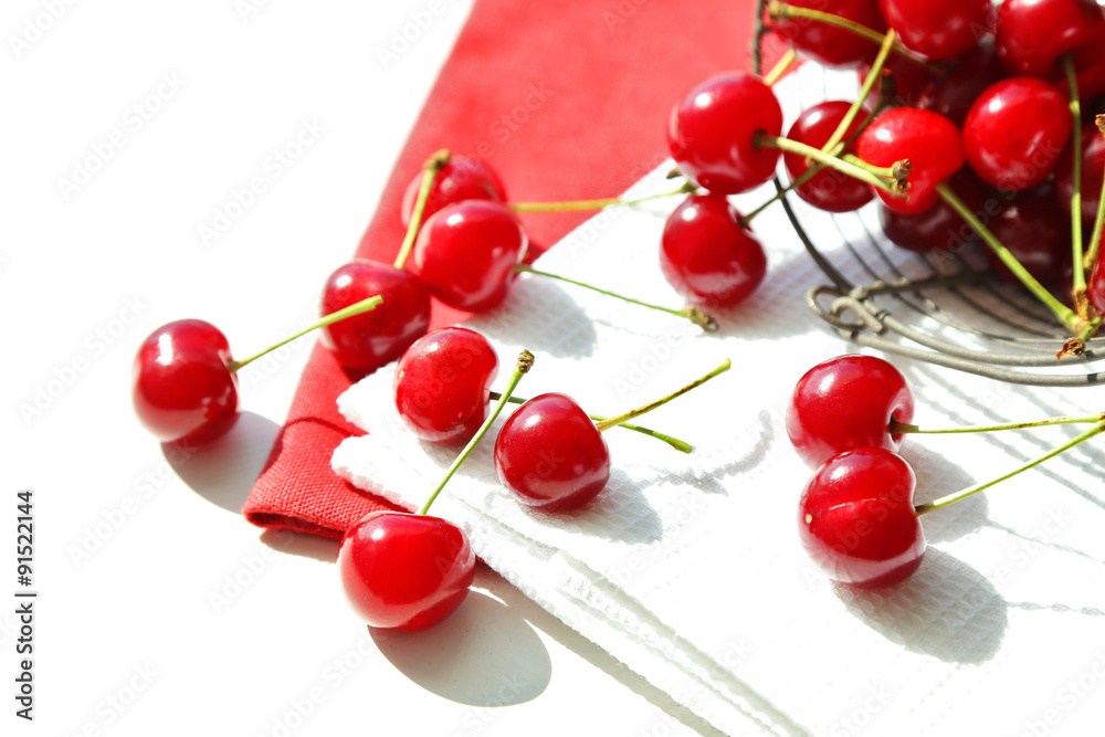 Cherries in basket on table, on light background Cherries in basket on table, on light background