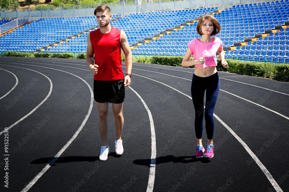 Obraz premium Young people jogging on stadium