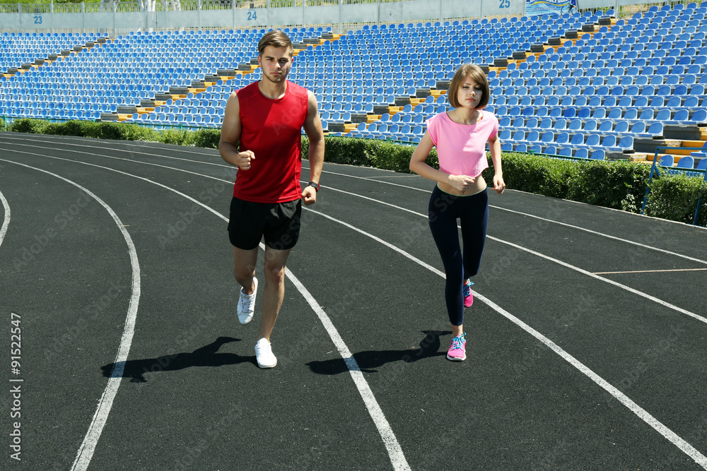 Obraz premium Young people jogging on stadium