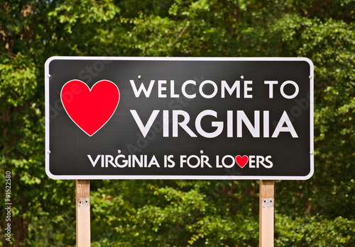 Photo Virginia is for Lovers, state moto and welcome sign on a billboard sorrounded by