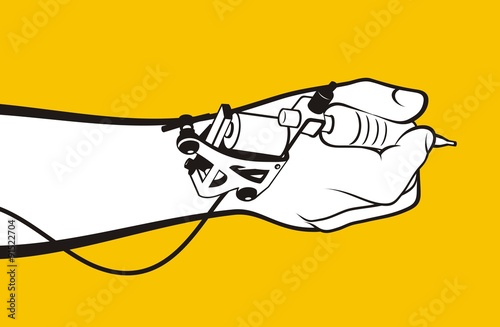 Hand holding tattoo machine