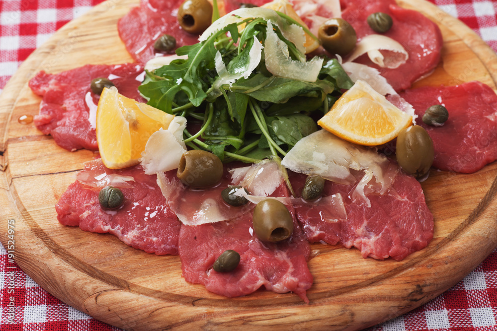 Beef carpaccio with capers and rocket salad
