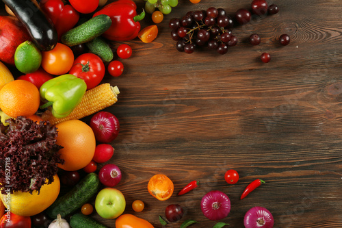 Heap of fruits and vegetables on wooden background