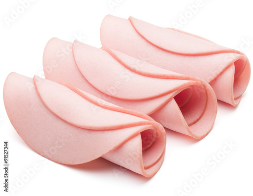 cooked boiled ham sausage or rolled bologna slices isolated on w