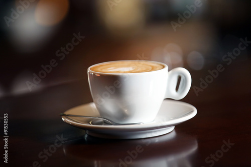 Cup of cappuccino on bar counter