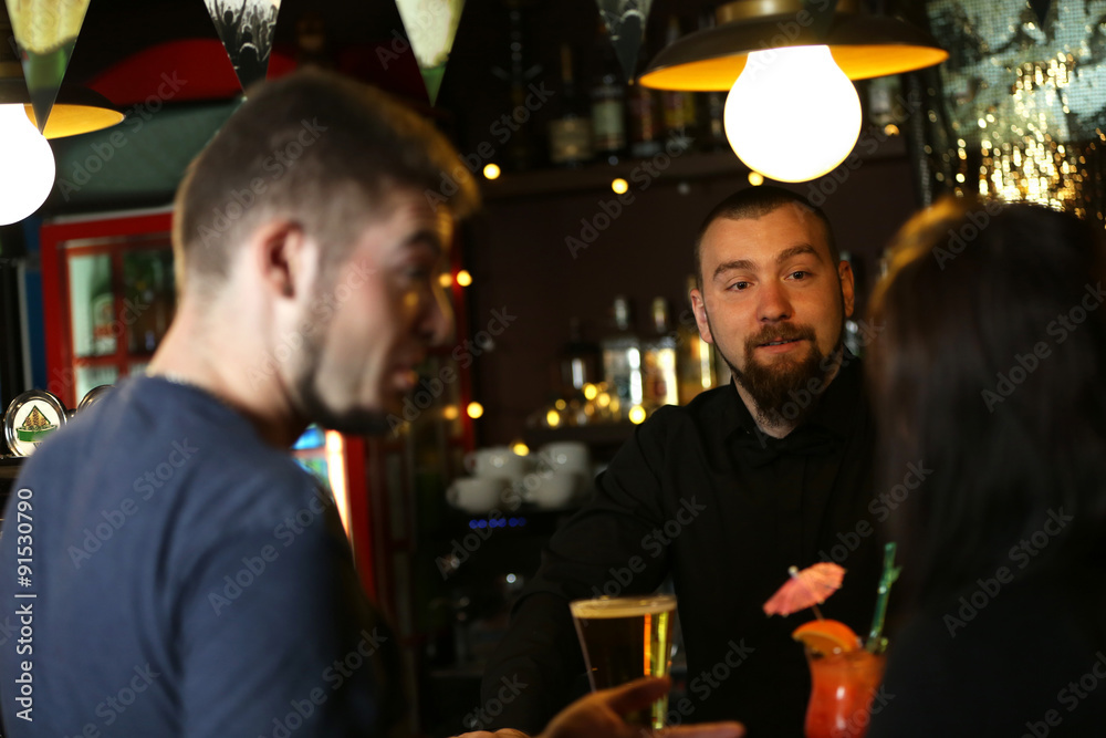 Young man and woman drinking in bar Young man and woman drinking in bar