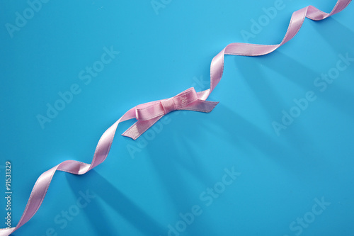 Pink ribbon on blue background