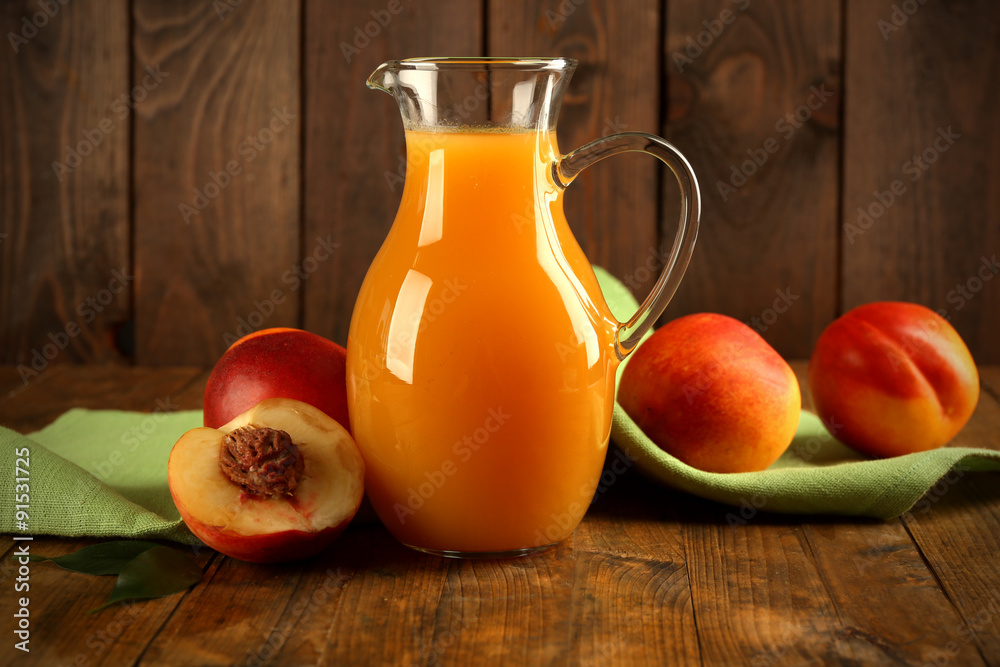 Peach juice and ripe peaches on wooden background Peach juice and ripe peaches on wooden background