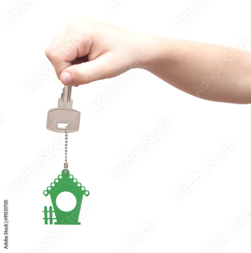 House key in kids hand over white background
