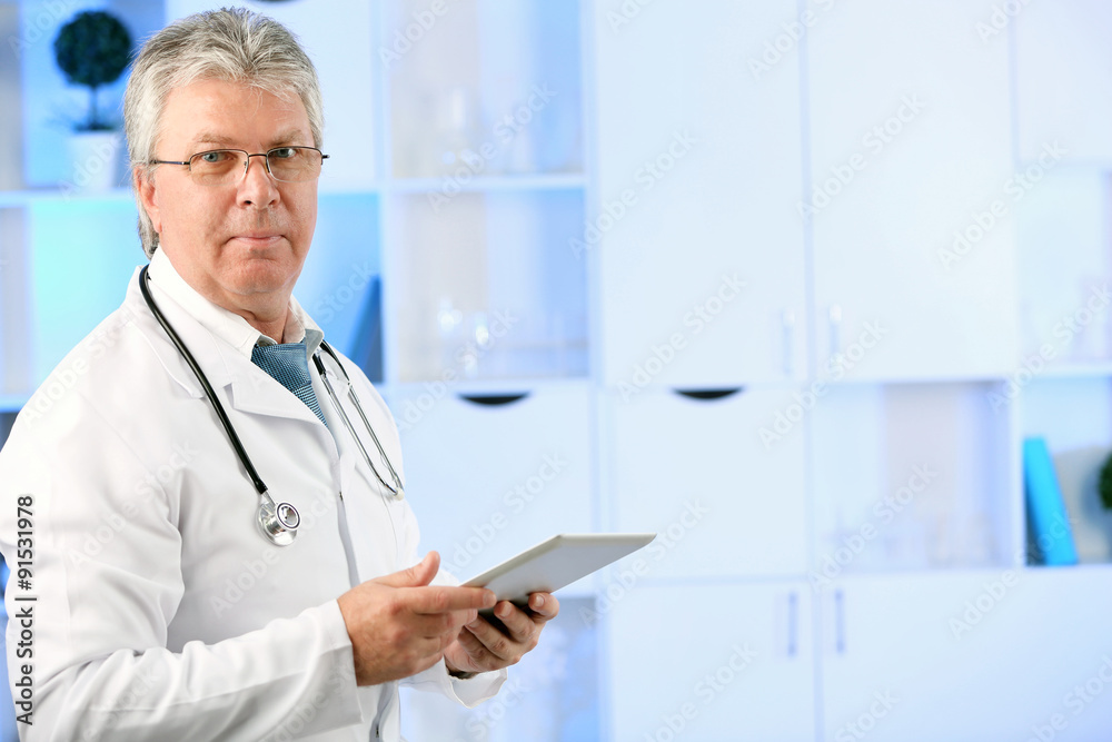 Doctor with digital tablet at his workplace Doctor with digital tablet at his workplace
