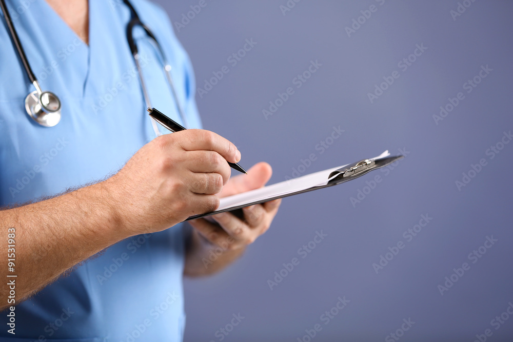 Doctor with clipboard on blue background