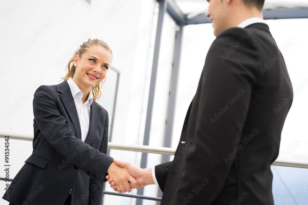 Business man and woman handshake at office Business man and woman handshake at office