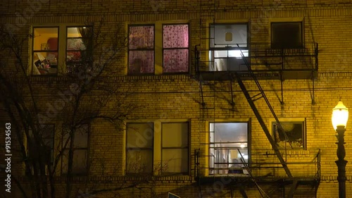 Generic establishing shot of an urban tenement or apartment complex at night.