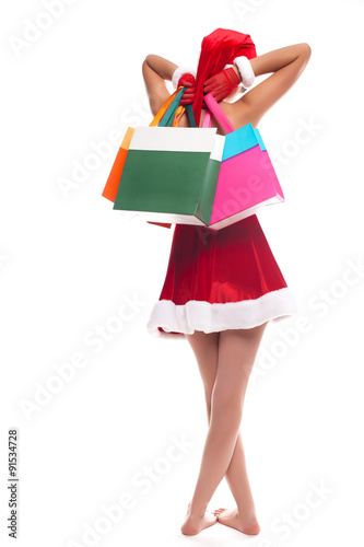 Christmas girl holding shopping bags, rear view portrait isolate