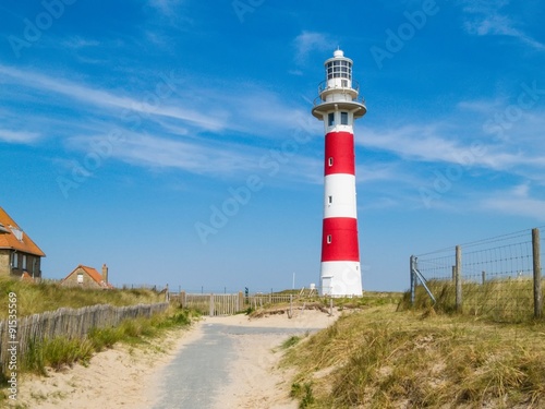Road to lighthouse in the dunes. Coast of the North Sea, Belgium