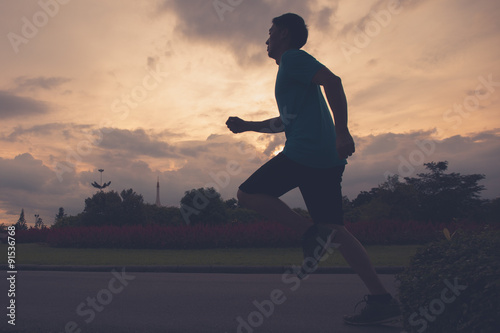 Fotografie Runner athlete silhouette running in public park