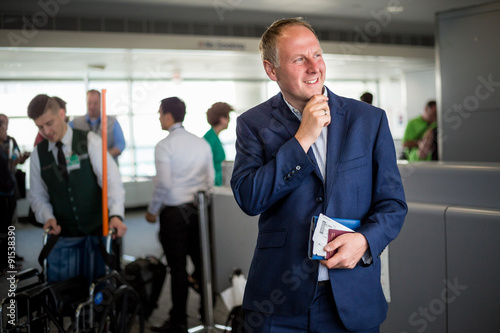 Businessman with passport and boarding pass at the airport