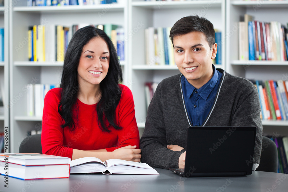 Happy students learning in library Happy students learning in library