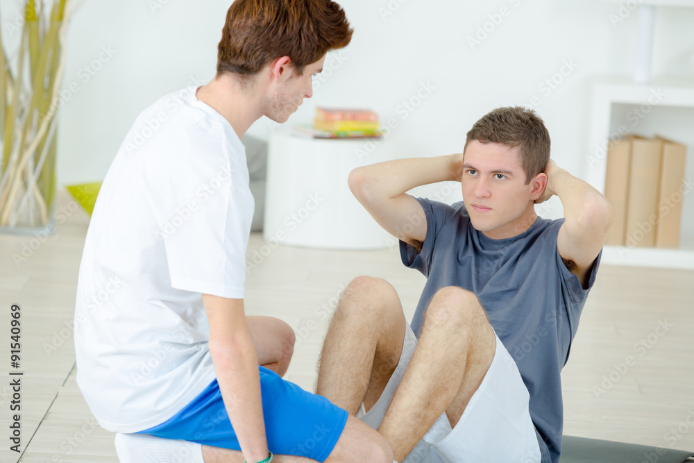 Obraz premium Teenage boys doing sit ups