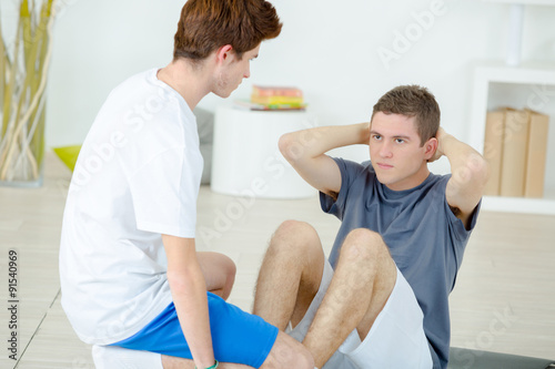 Teenage boys doing sit ups