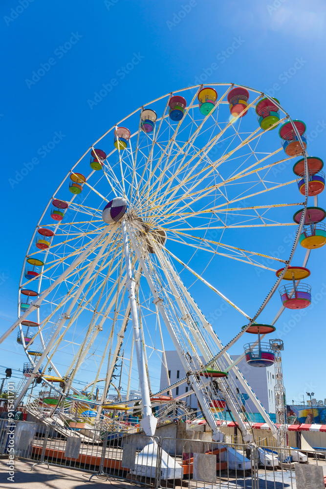 Giant ferris wheel in Amusement park with blue sky background