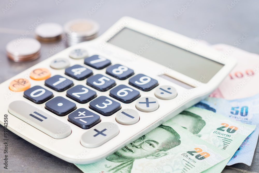 Calculator with money on grey background Calculator with money on grey background