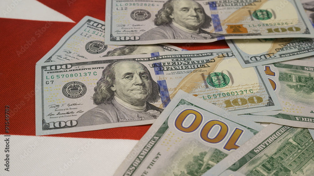 canadian flag and lots of hundred dollar bills canadian flag and lots of hundred dollar bills
