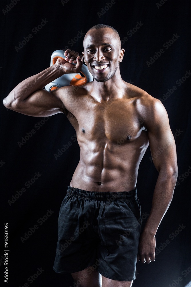 Portrait of happy muscular man holding kettlebell Portrait of happy muscular man holding kettlebell